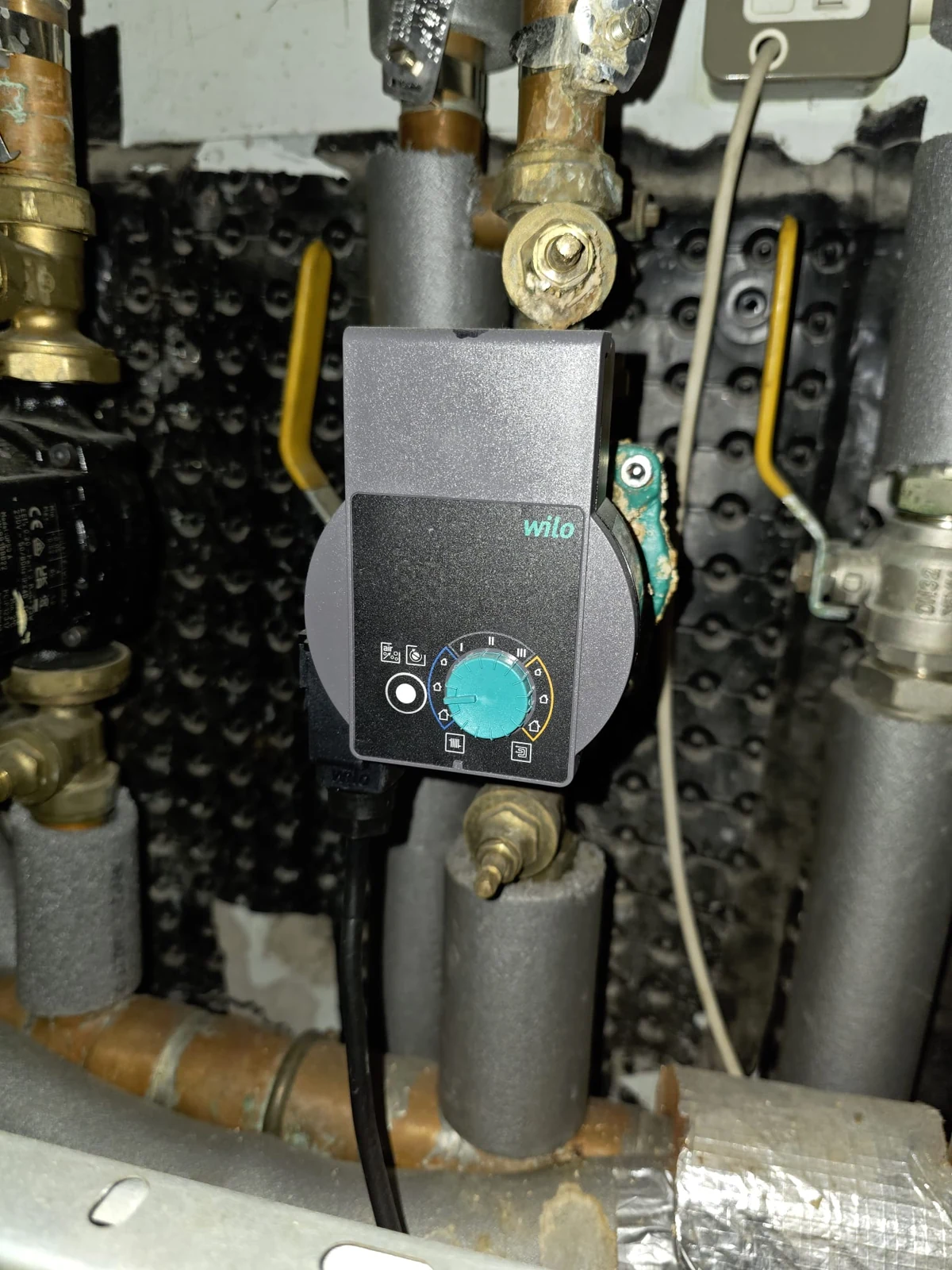 Replacement Wilo circulation pump fitted within insulated heating pipework