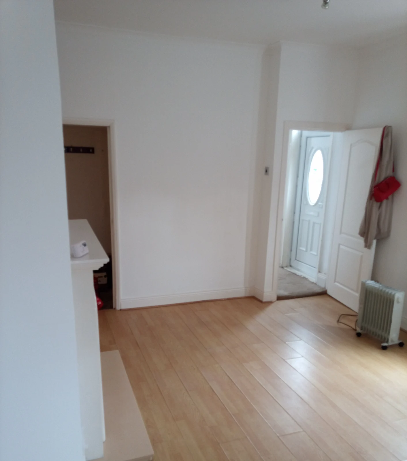 Decorated reception room with neutral walls and timber-effect flooring