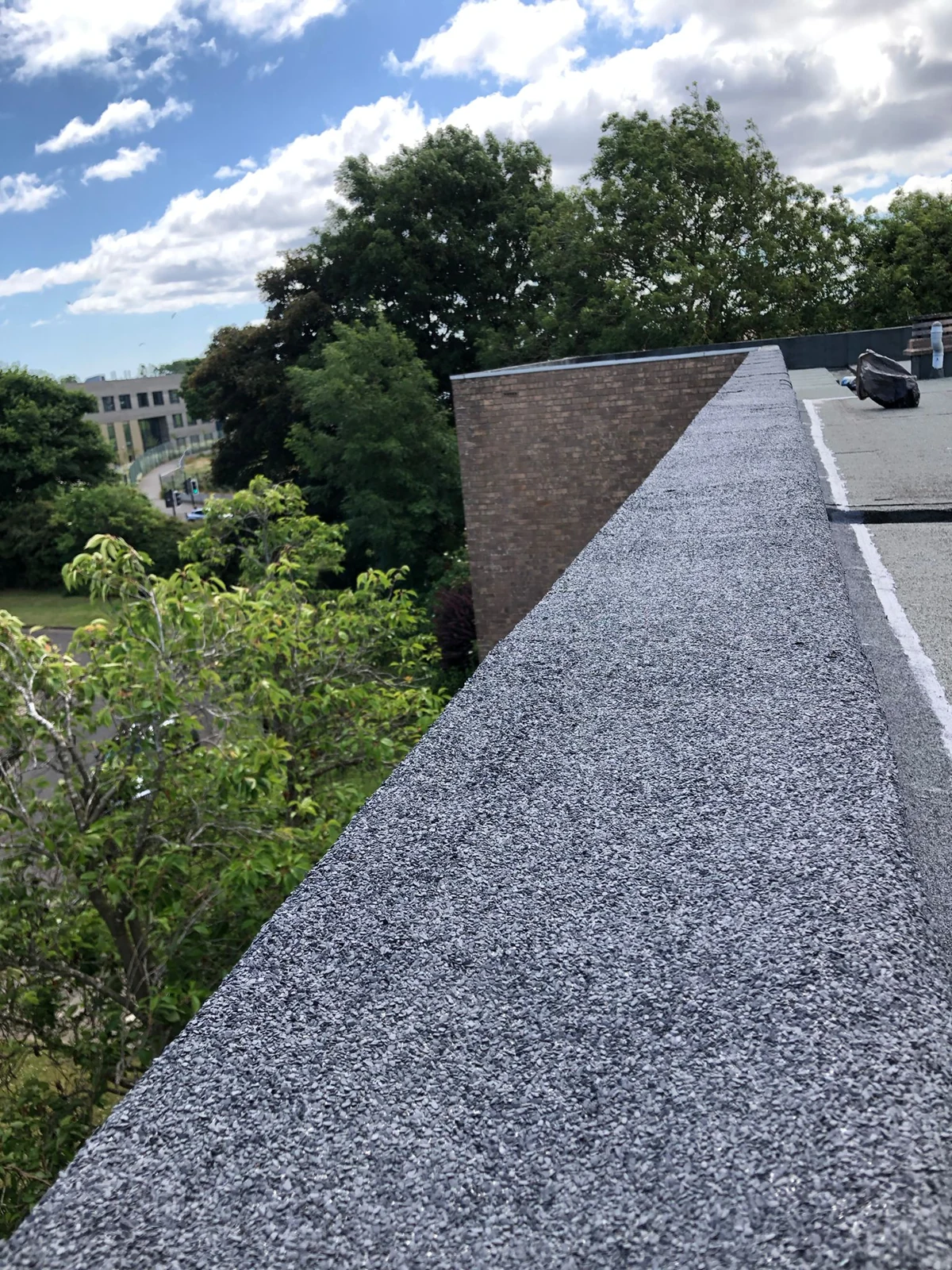 Renewed parapet capping along the roof edge