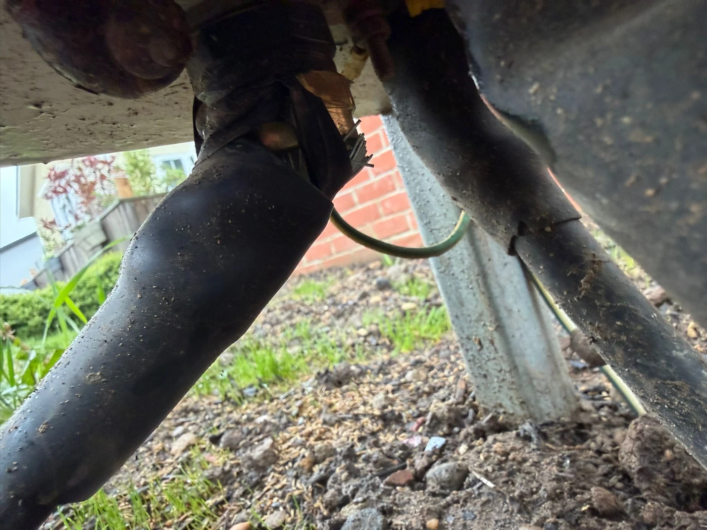 Supply cable and connections inspected beneath a residential park unit