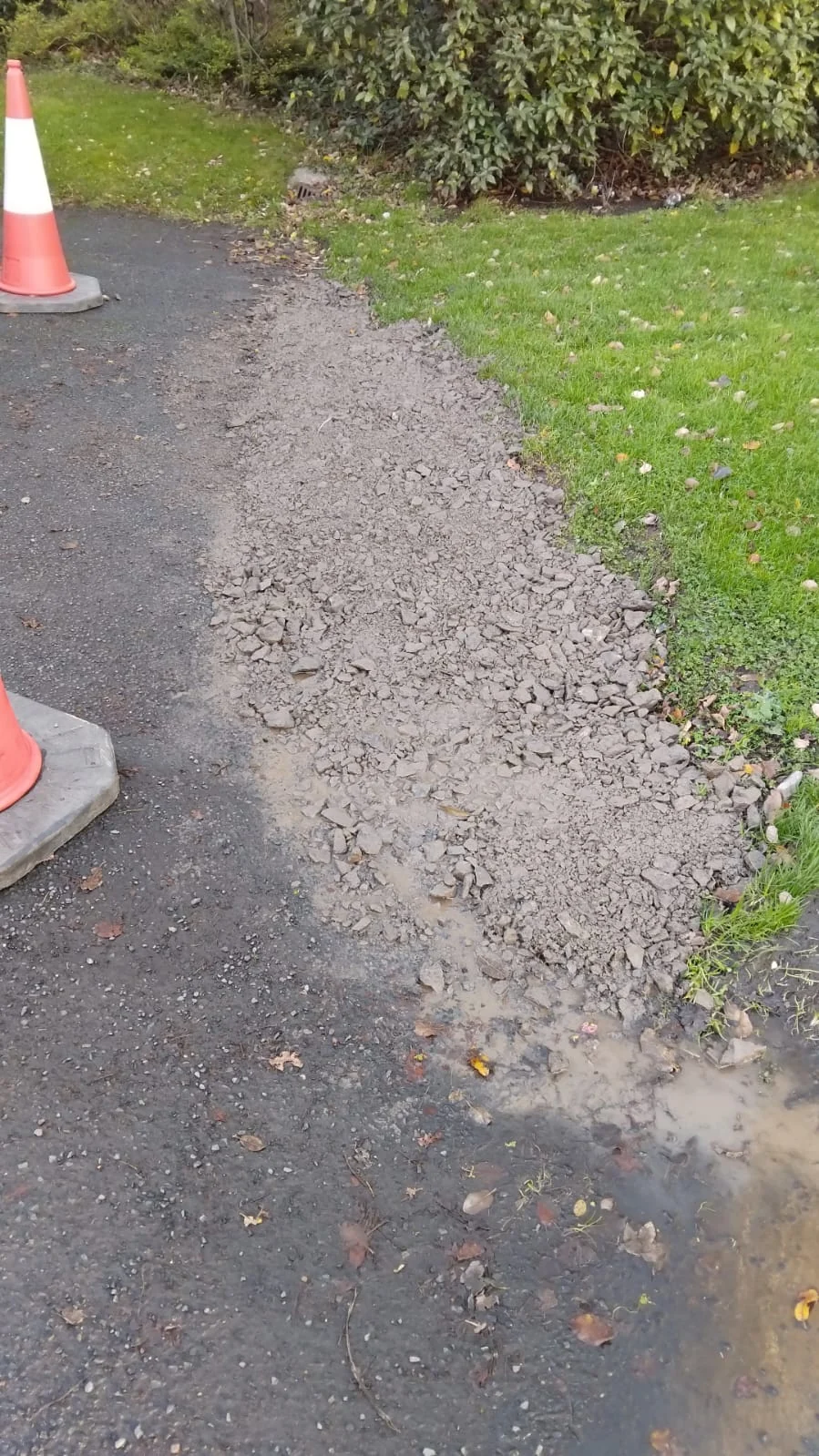 Aggregate infill along the edge of a car park beside a grass verge